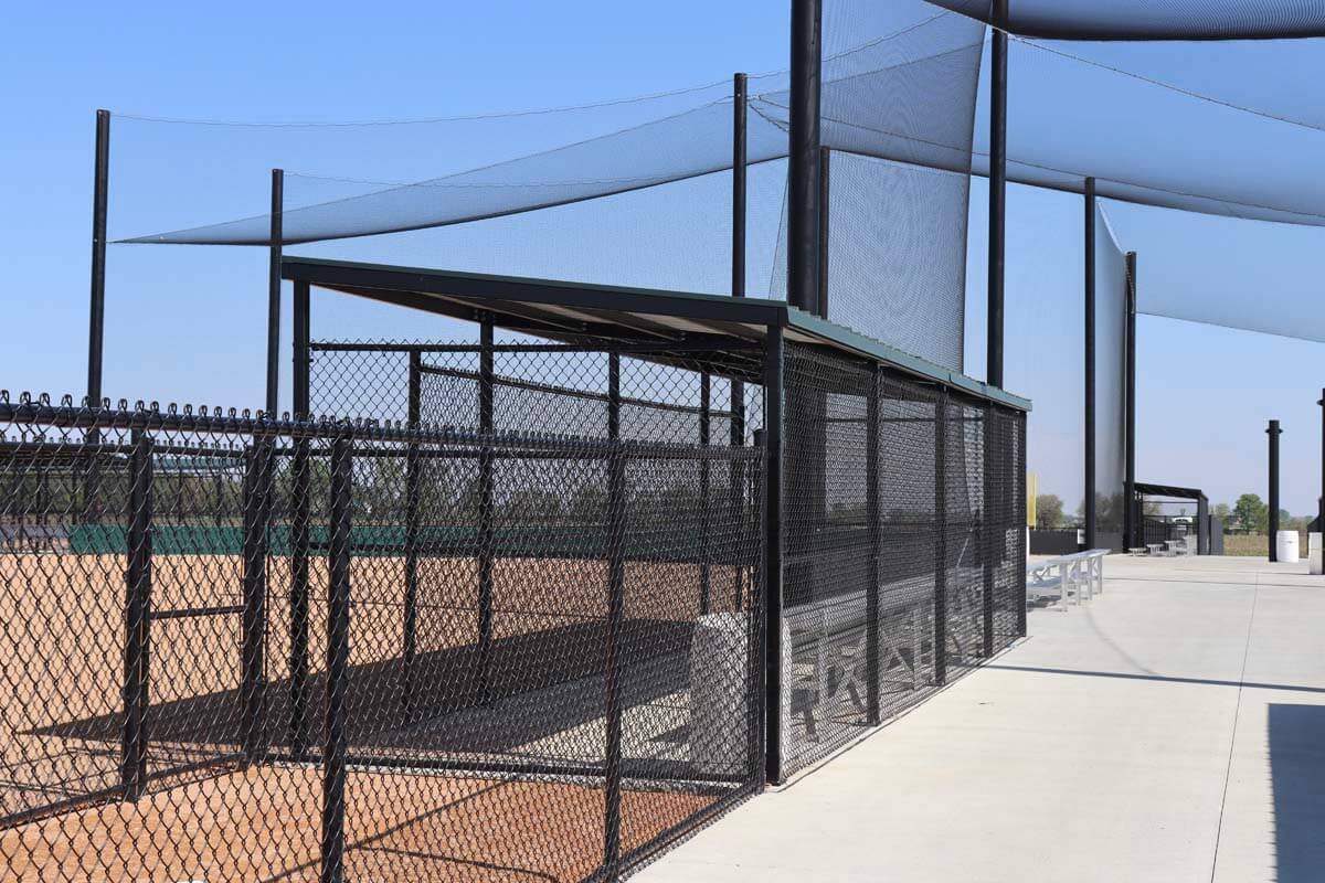 Baseball field cantilever dugout and bat rack